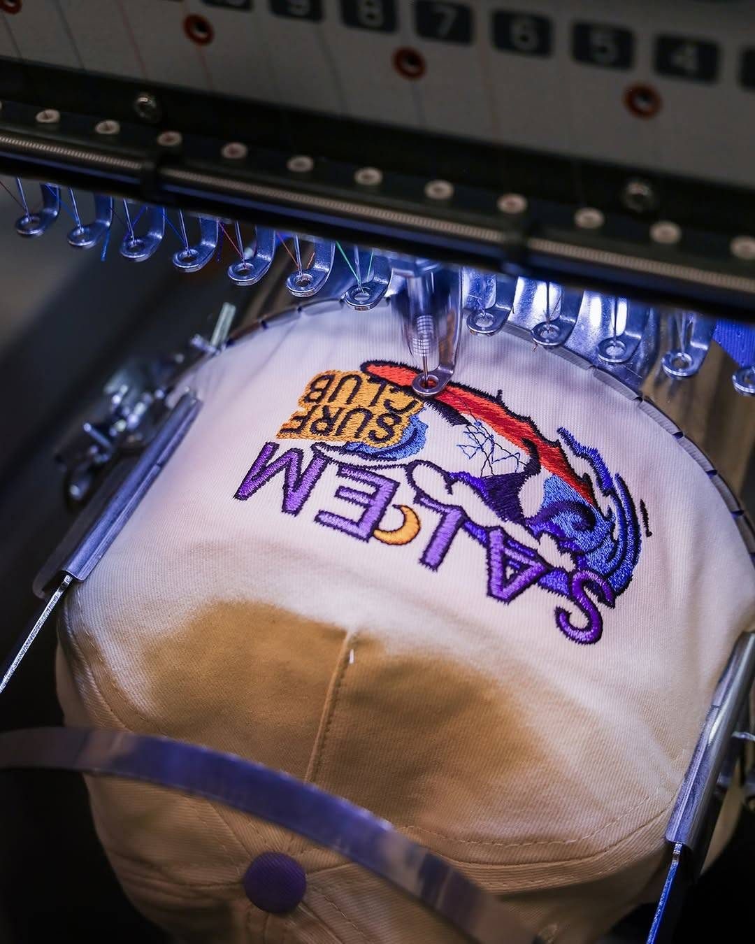 Embroidery machine stitching a cap